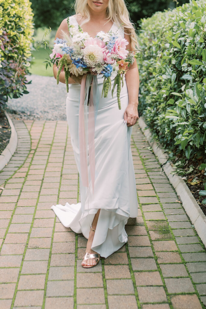 Bride carrying a loose locally grown wedding bouquet at Corick House Hotel