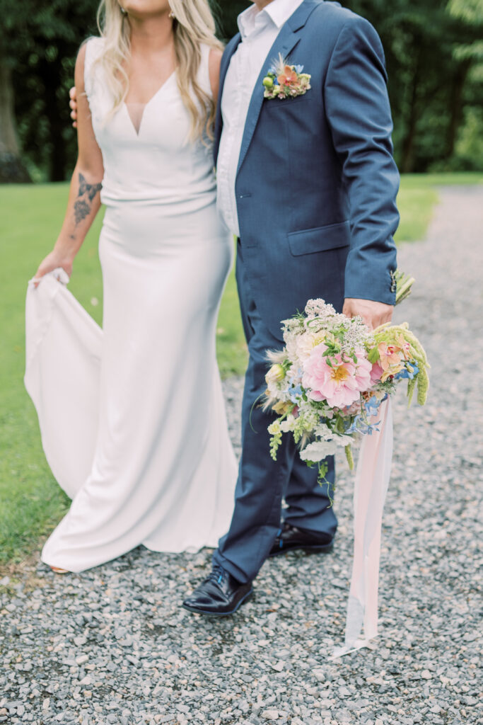 Couple with loose seasonal bridal bouquet at Corick House Hotel