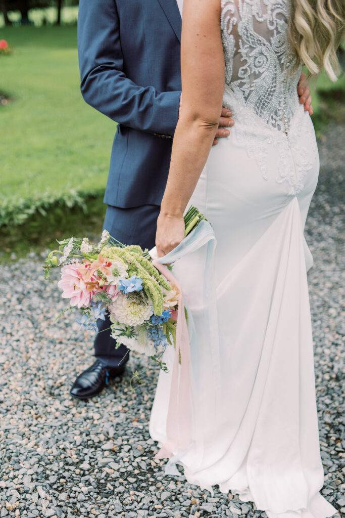 Bride holding a loose locally grown bridal bouquet with soft seasonal flowers