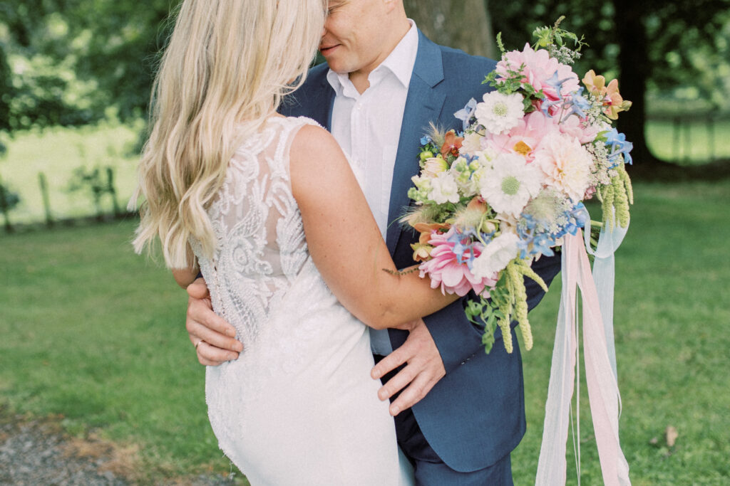 Couple with colourful seasonal bridal bouquet at Corick House Hotel
