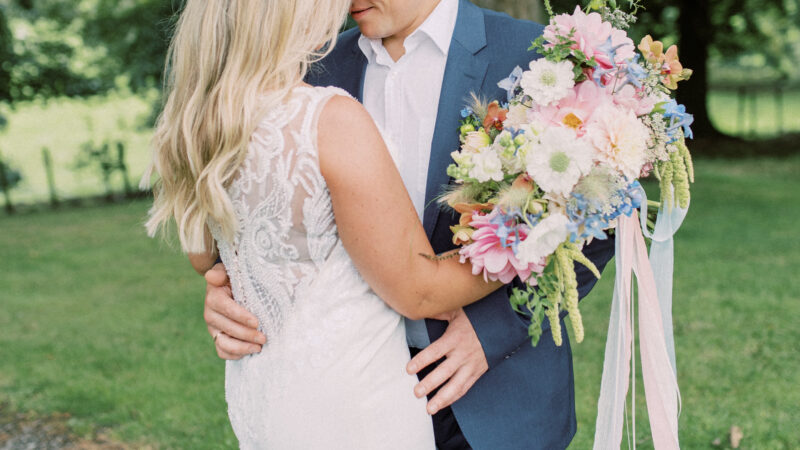 Couple with colourful seasonal bridal bouquet at Corick House Hotel