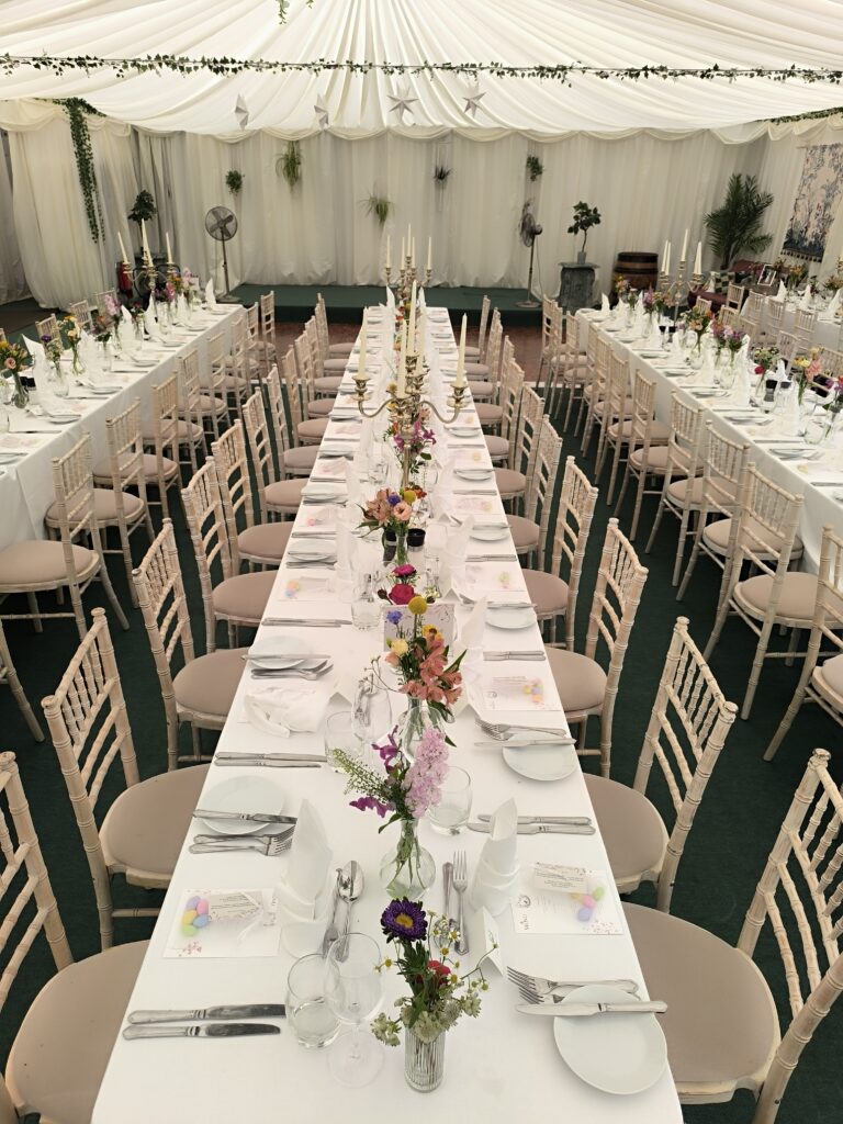 Long wedding tables with colourful bud vase flowers at Martinstown House