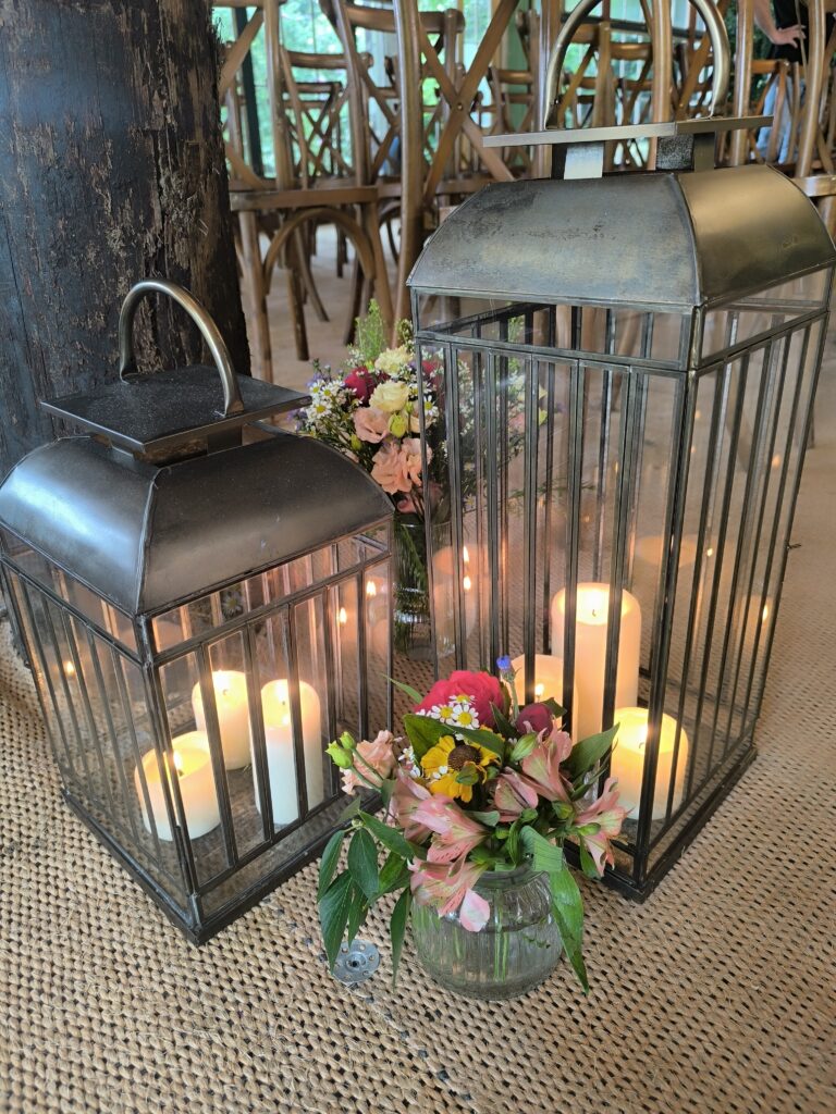Lanterns and colourful flowers for an outdoor ceremony at Martinstown House